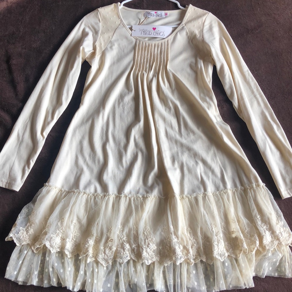 A light yellow, lace, long sleeve dress